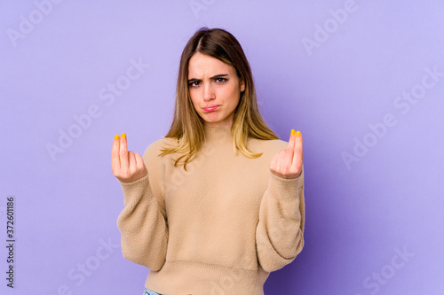 Young caucasian woman isolated on purple background showing that she has no money.