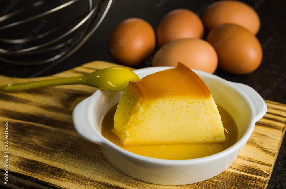 Fototapeta premium Traditional Brazilian dessert, milk pudding on dark background.