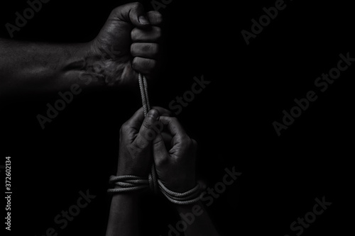 woman hands bound prisoner in room