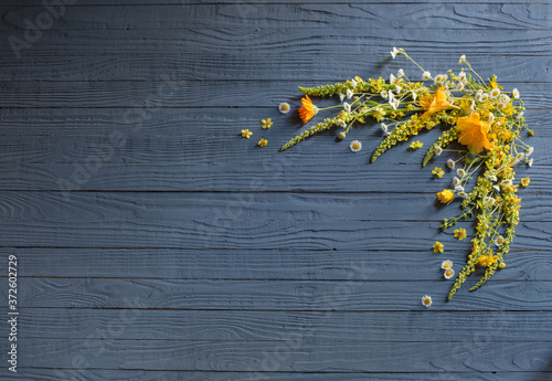 yellow summer flowers on blue wooden background