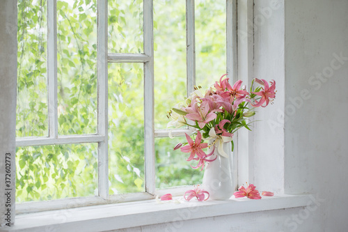 summer flowers in vase on white windowsill