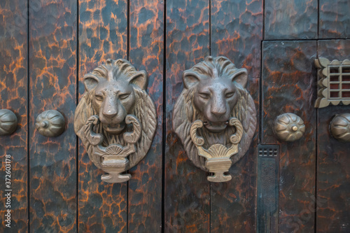 Cartagena, Colombia, August 20 2030: Knocker with a lion on a wooden door in the old town of Cartagena