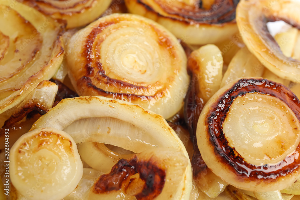 Tasty fried onion as background, closeup view Tasty fried onion as background, closeup view