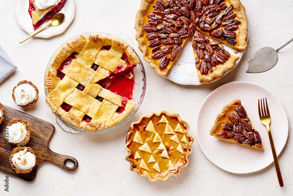 Top view shot of variety of thanksgiving pies: berry pie, pumpkin pie and pecan tart Top view shot of variety of thanksgiving pies: berry pie, pumpkin pie and pecan tart