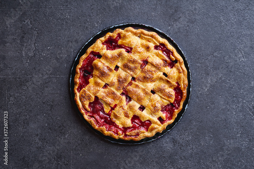 Top view image of cherry pie decorated with lattice photo