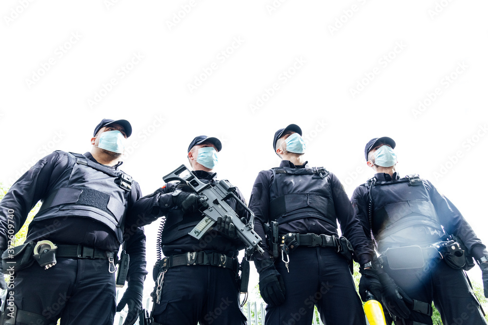 Full body squad of Spanish police officers in protective gears with
