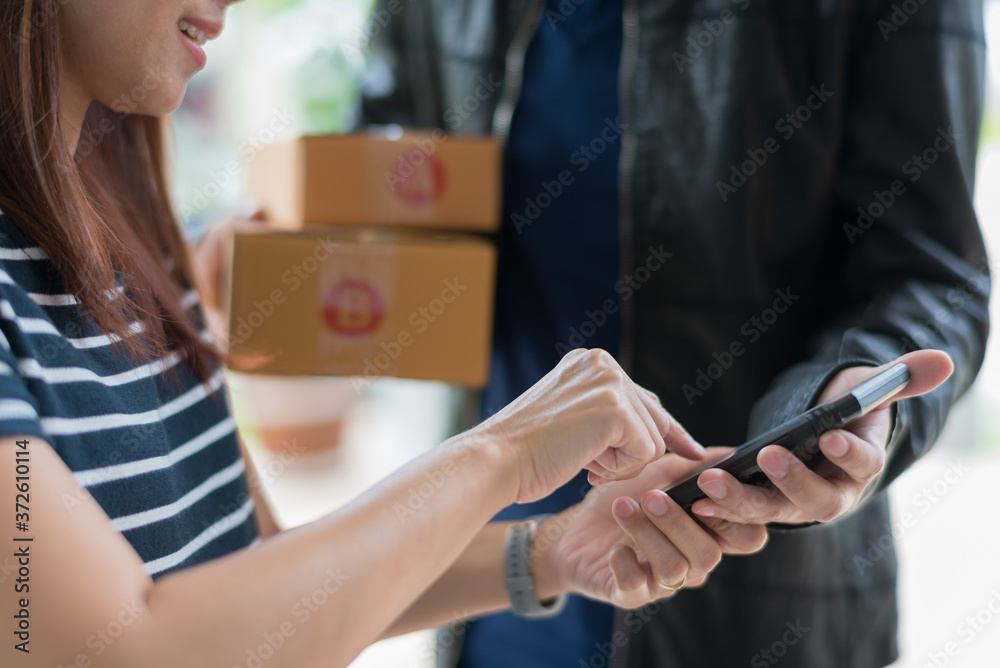 woman receive box from delivery man
