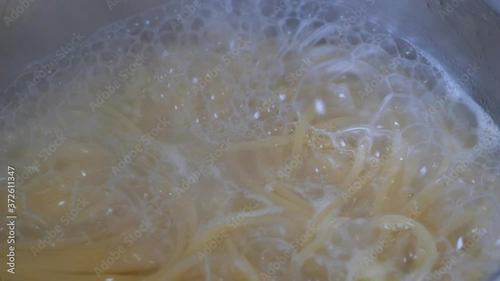 Boiling spaghetti in the hot water Boiling spaghetti in the hot water