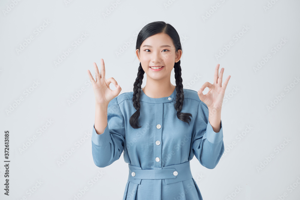 Asian woman show double OK hand sign and smile on white background Asian woman show double OK hand sign and smile on white background