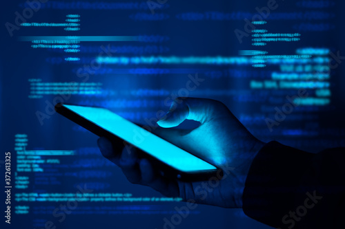Hackers are stealing information, hand holds smartphone.