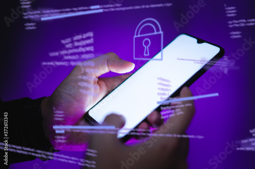 Hackers are stealing information, hand holds smartphone.