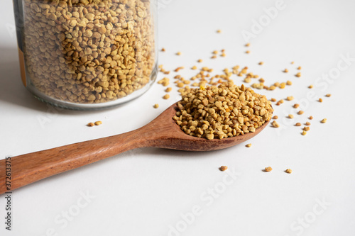 Close up bee pollen on a wooden spoon.