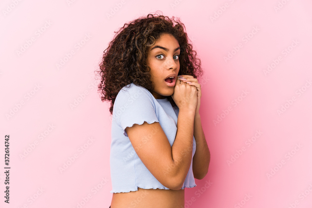 Young african american woman against a pink background scared and afraid. Young african american woman against a pink background scared and afraid.