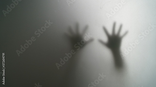 shadow of the right hand and left behind the glass is wet.	 photo