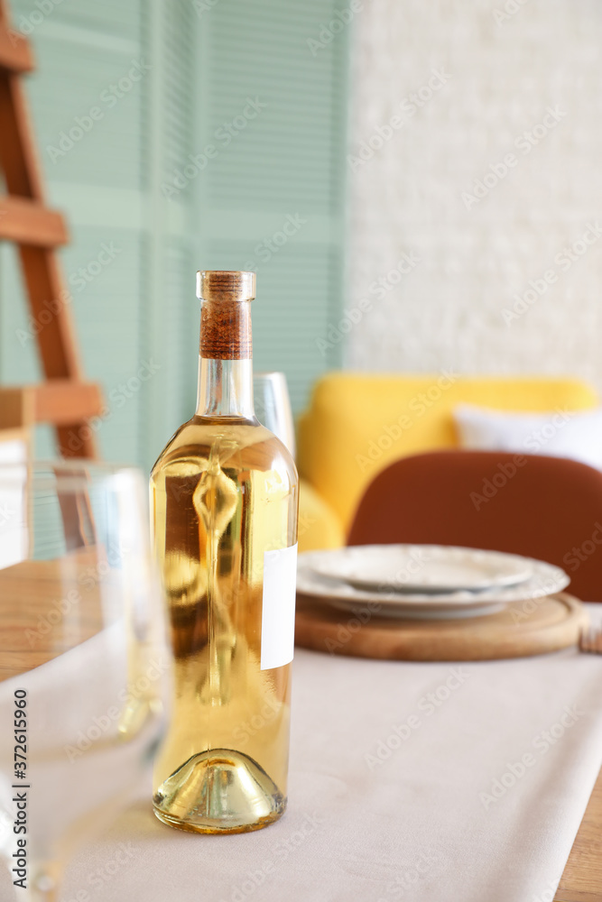 Bottle of wine on table in dining room Bottle of wine on table in dining room