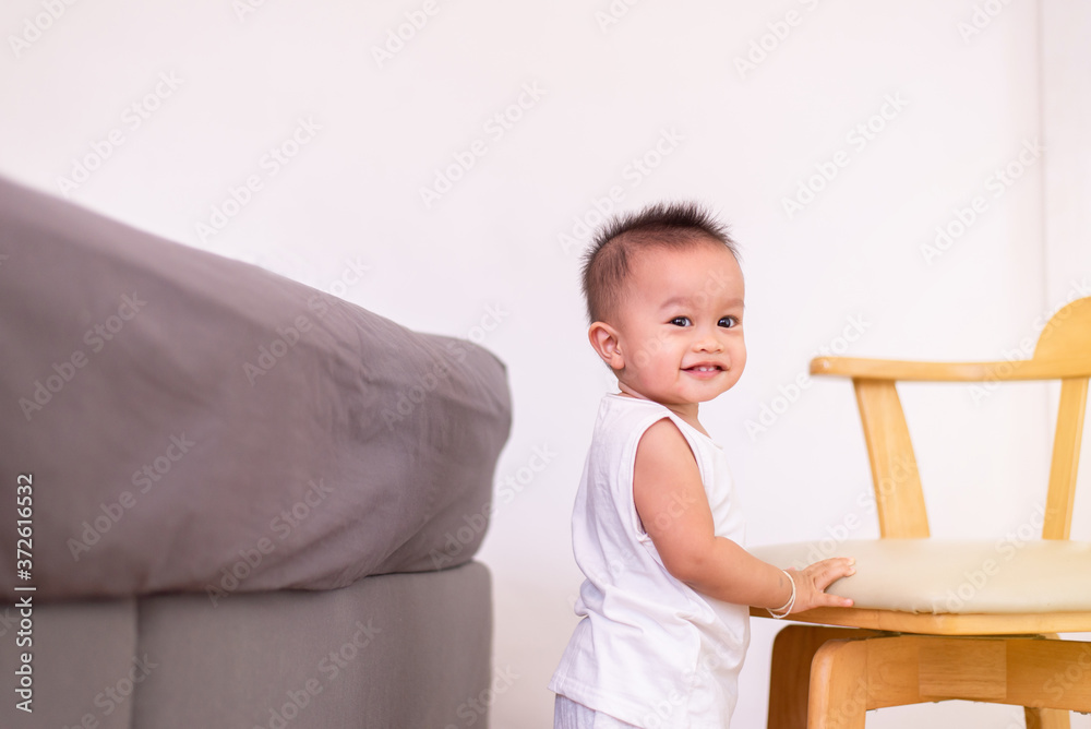 Adorable asian baby boy standing in bedroom,Happy and laughing new born kid Adorable asian baby boy standing in bedroom,Happy and laughing new born kid