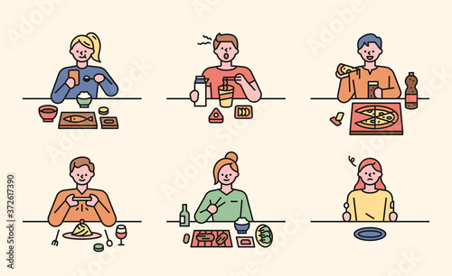 People are sitting at each table and eating a variety of foods.