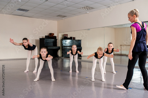 The choreographer teaches children dances. photo