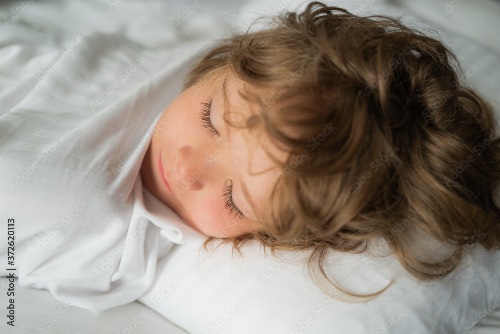 Calm adorable kids lying on soft pillows. Kids sleeping. Six years old Kid sleep in bed. Calm adorable kids lying on soft pillows. Kids sleeping. Six years old Kid sleep in bed.