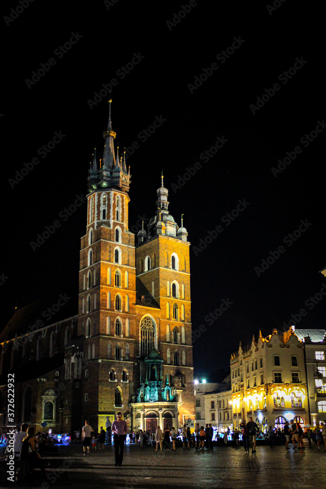 Krakow, Poland - July 20, 2017: In Summer Evening People Walk On The Main Square In Royal City Krakow In Poland.