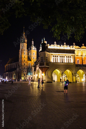 Krakow, Poland - July 20, 2017: In Summer Evening People Walk On The Main Square In Royal City Krakow In Poland.