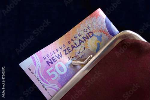 New Zealand dollars in a red purse.