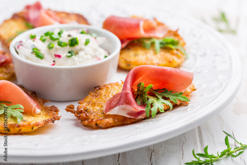Potato pancake with prosciutto and dip of radishes cream cheese and chives Potato pancake with prosciutto and dip of radishes cream cheese and chives
