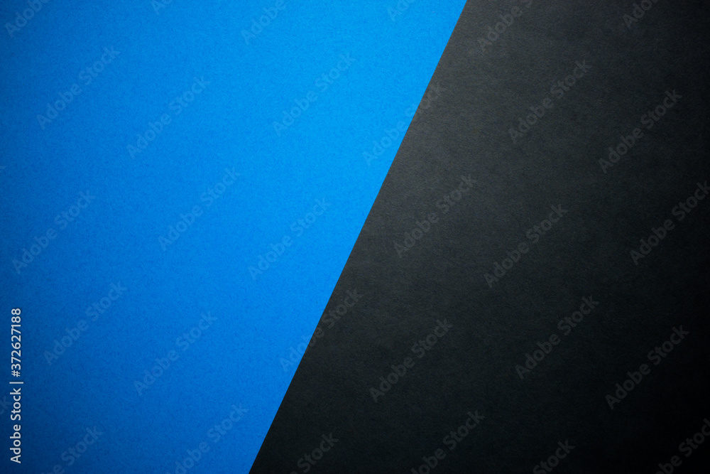Diagonally divided blue and black background, colored paper Diagonally divided blue and black background, colored paper
