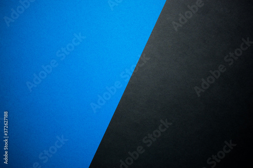 Diagonally divided blue and black background, colored paper