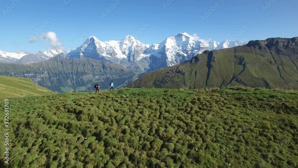FOLLOW SHOT OF TOURISTS WALKING WIH SNOW CAP MOUNTAINS FOLLOW SHOT OF TOURISTS WALKING WIH SNOW CAP MOUNTAINS