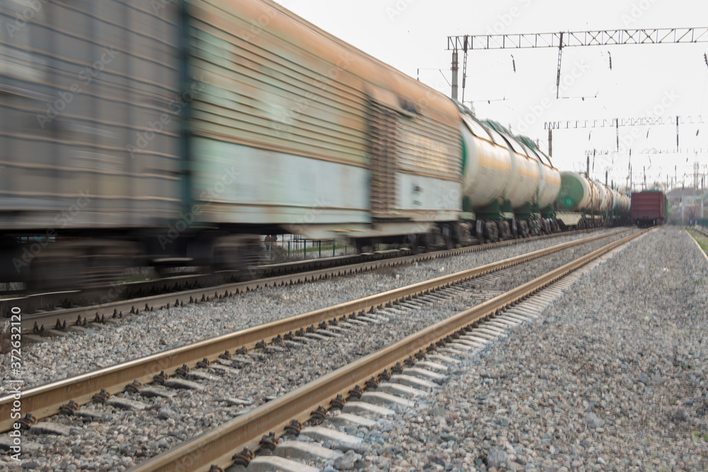 freight train moves fast during sunset.