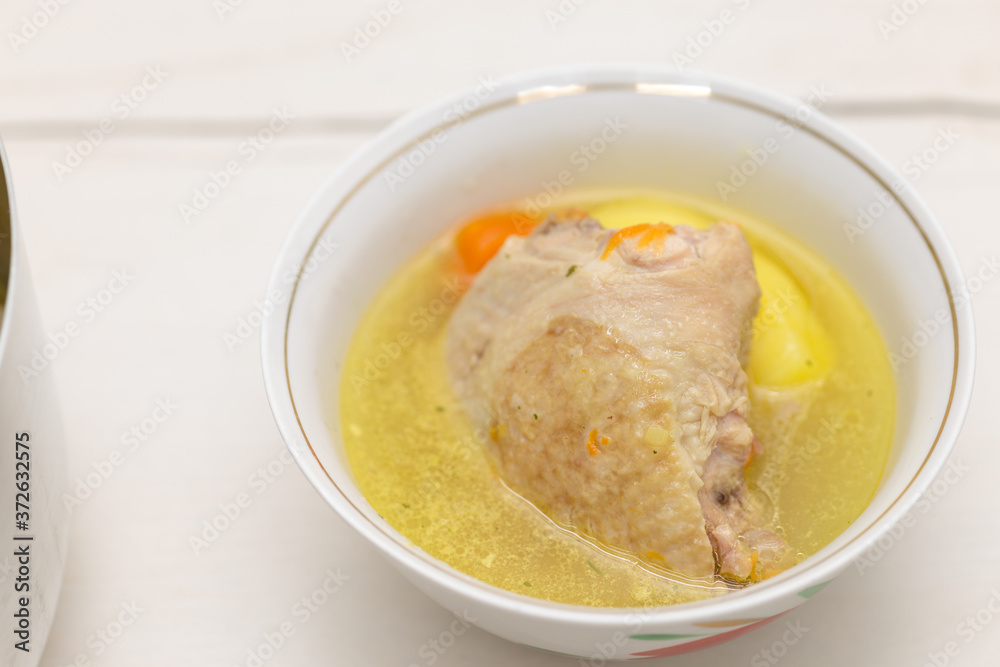 chicken soup on a white table chicken soup on a white table