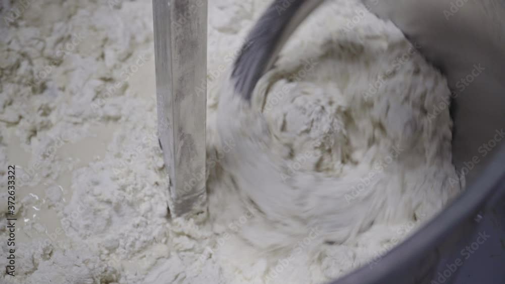 Spiral Mixer Mixing Dough In An Artisan Bakery In Zitsa, Greece - overhead shot Spiral Mixer Mixing Dough In An Artisan Bakery In Zitsa, Greece - overhead shot