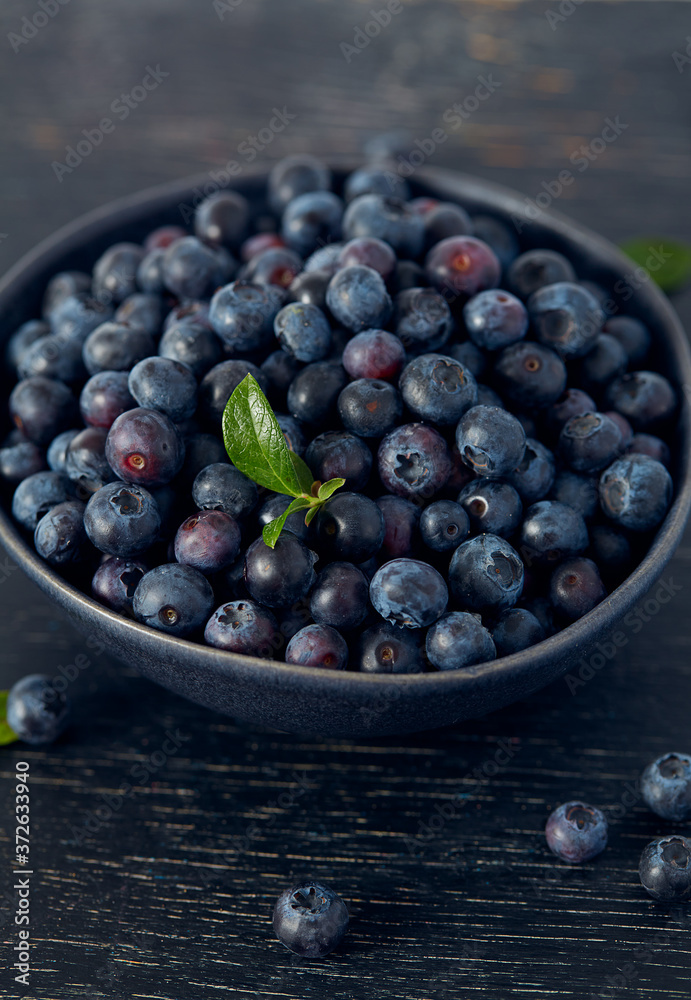 fresh blueberries on dark wooden surface fresh blueberries on dark wooden surface