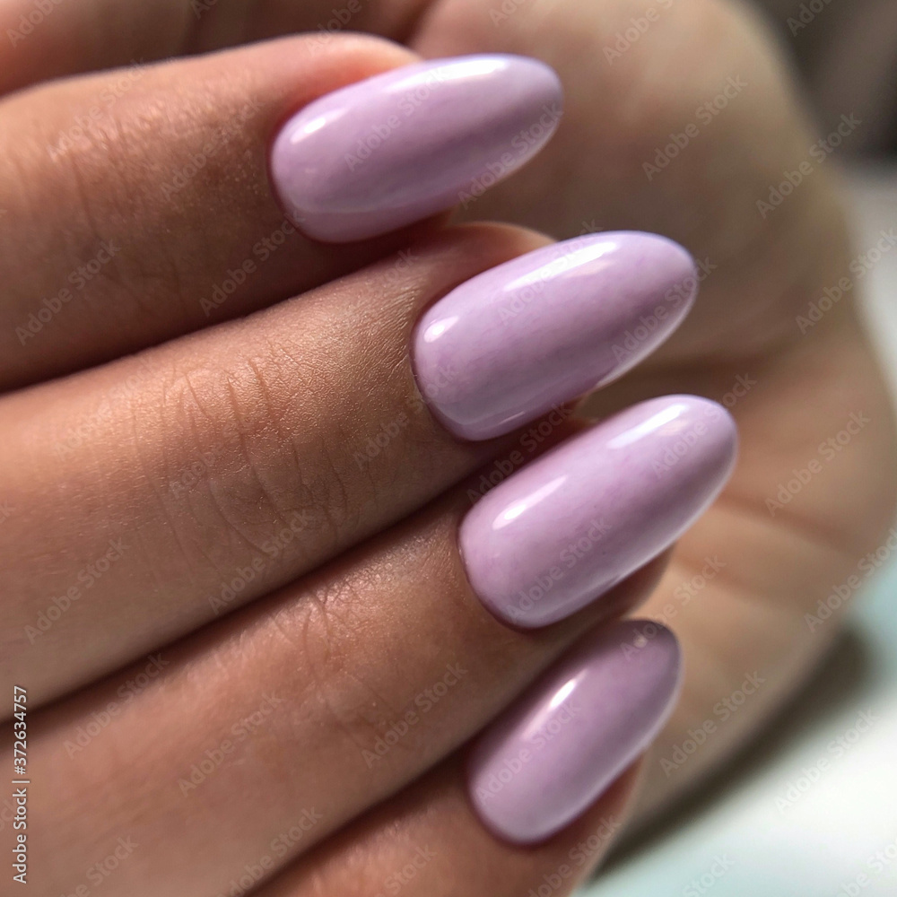 Stylish trendy female pink manicure.Hands of a woman with pink manicure on nails Stylish trendy female pink manicure.Hands of a woman with pink manicure on nails