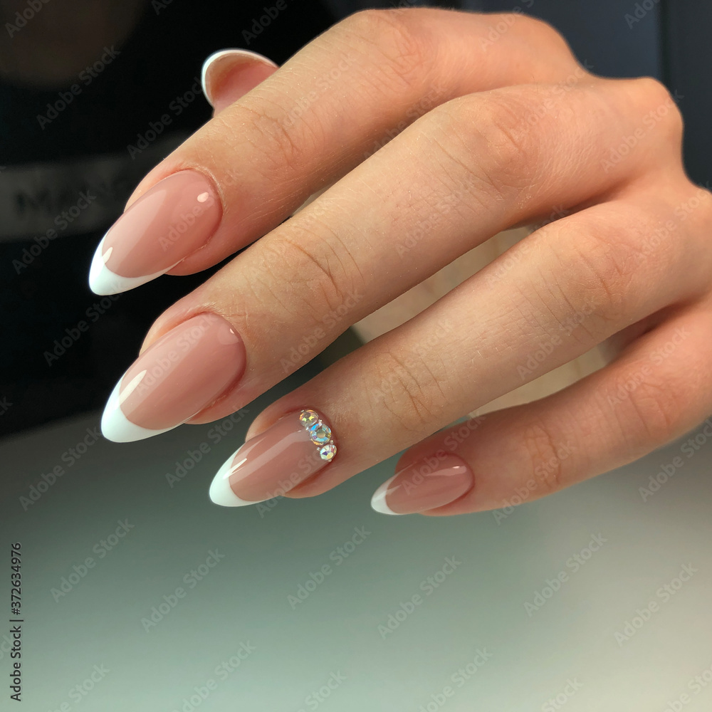 French manicure on the nails. French manicure design. Manicure gel nail  polish Stock Photo