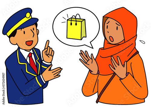 荷物を失くして駅員に相談するアジア人女性