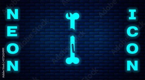 Glowing neon Human broken bone icon isolated on brick wall background. Vector.