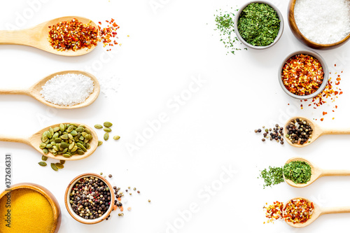 Asian and Indian spices and herbs in wooden spoons for cooking