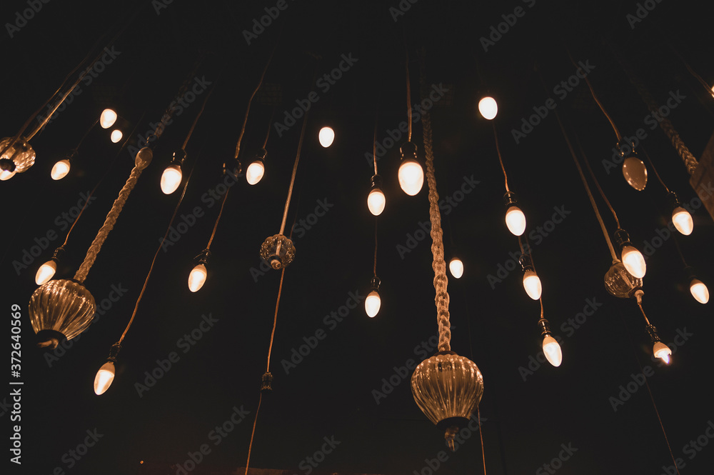 Many lamps hanging from the ceiling