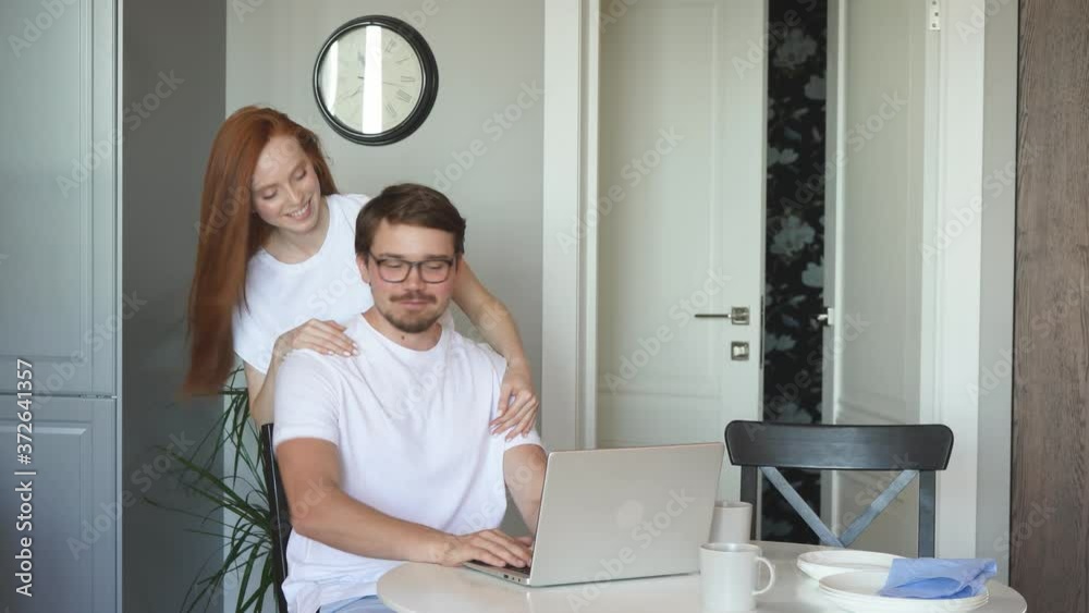 Vidéo Stock Adorable female hugs her working husband from back, they ...