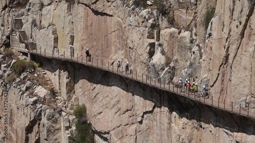 Hikers walk along the renovated Caminito Del Rey walkway in Spain