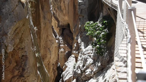 Cinematic vertical pan of the river and Caminito Del Rey walkway
