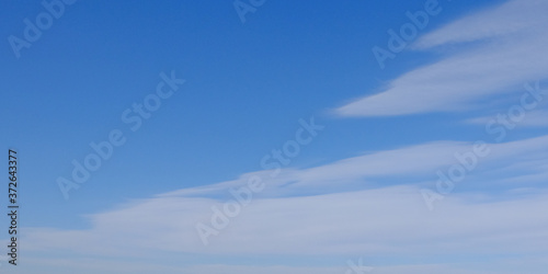 Blue spring sky with white clouds. Beautiful background.