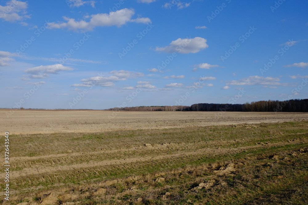 Beautiful cloudy sky over farmland. Spring landscape. Beautiful cloudy sky over farmland. Spring landscape.