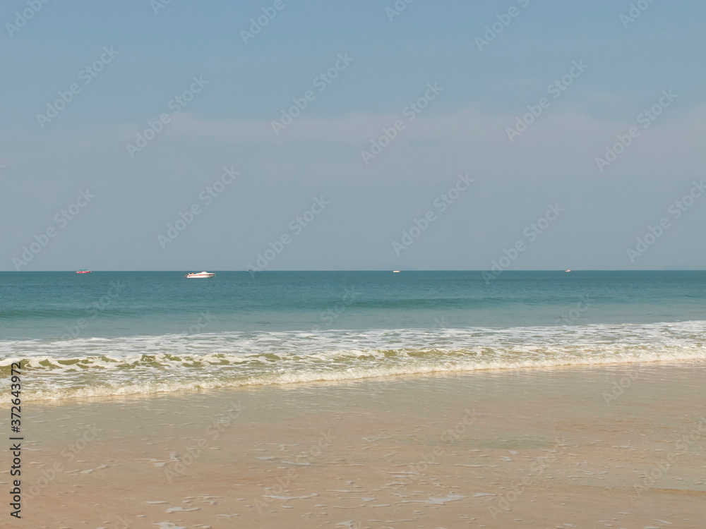 Deserted sandy beach and slightly surfing sea in the morning. Secluded deserted place to rest Deserted sandy beach and slightly surfing sea in the morning. Secluded deserted place to rest