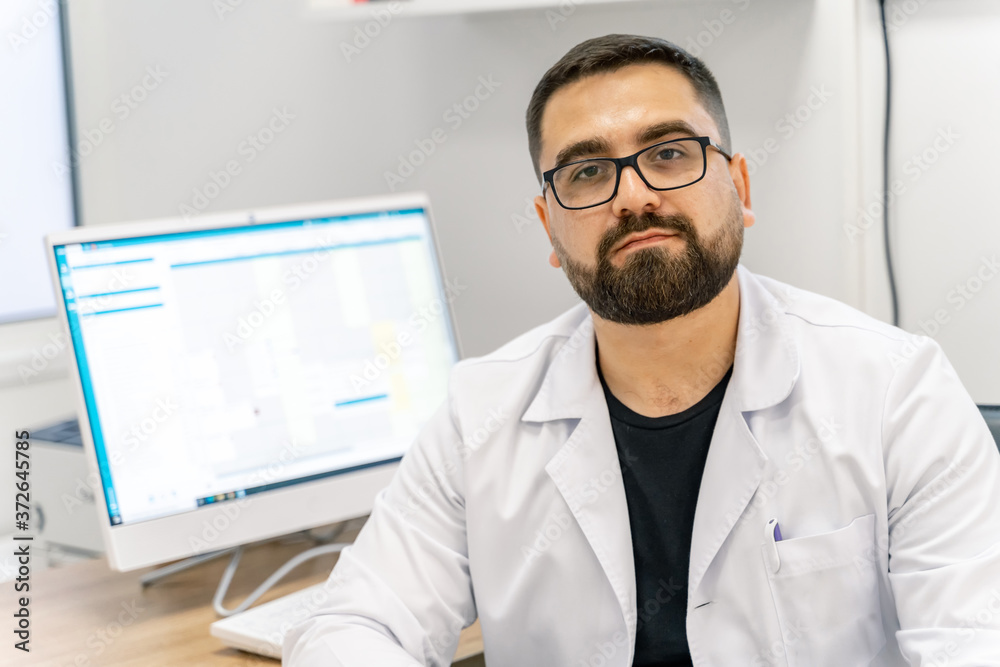 Mature male doctor looking at x-ray isolated on modern office backgound. Healthcare, people and medicine concept. Mature male doctor looking at x-ray isolated on modern office backgound. Healthcare, people and medicine concept.