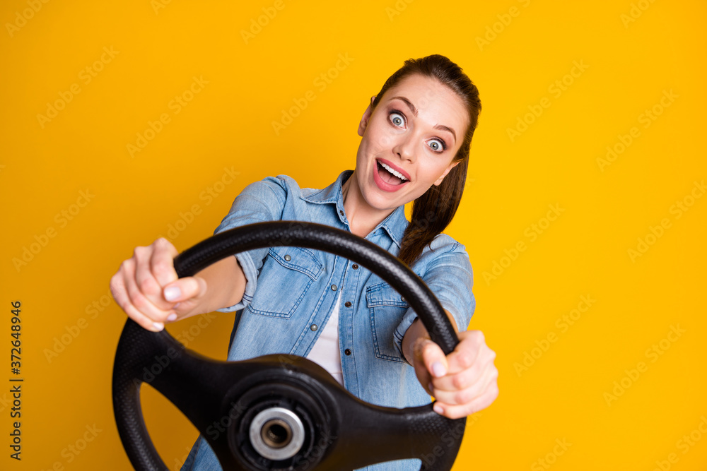 Photo of astonished positive funny girl drive car hold steering wheel impressed wear style stylish trendy clothes isolated over bright shine color background Photo of astonished positive funny girl drive car hold steering wheel impressed wear style stylish trendy clothes isolated over bright shine color background