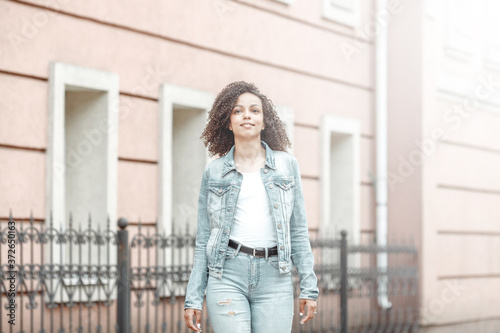 Happy young girl on sunny city street