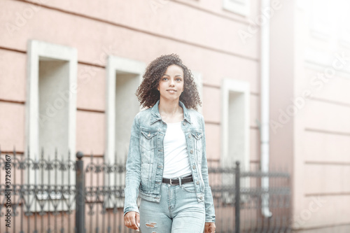 black curly girl on street © VERSUSstudio